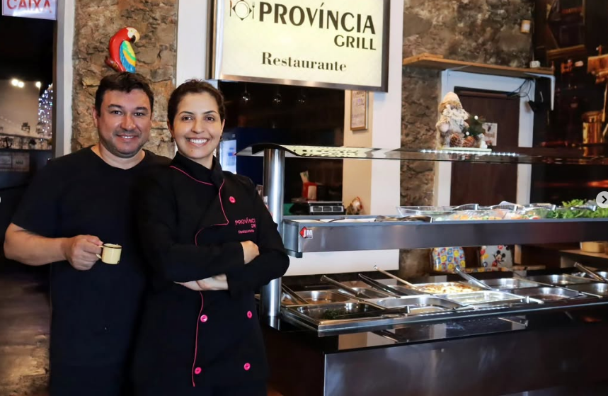 Carlos e Daniela, donos do Província Grill, em frente ao buffet